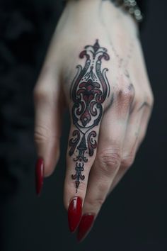 Elaborate black and red tattoo design on the ring finger of a hand with red nails. Filler Space Tattoo, Gothic Neck Tattoos Women, Cover Up Finger Tattoos, Meaningful Finger Tattoos, Unique Finger Tattoos, Witchy Finger Tattoos, Finger Tattoos Ideas, Finger Tattoos For Women, Baroque Tattoo