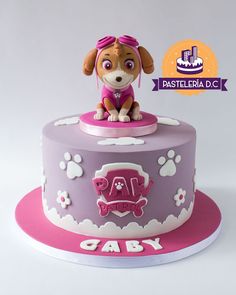 a cake that has a dog on top of it