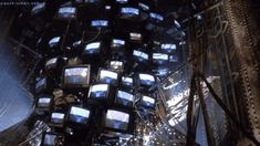 there are many televisions stacked on top of each other in the air and one is upside down