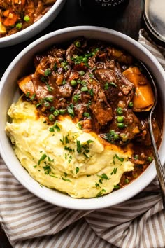 two bowls filled with mashed potatoes and beef