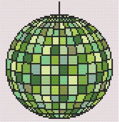 a cross stitch globe with green squares on it