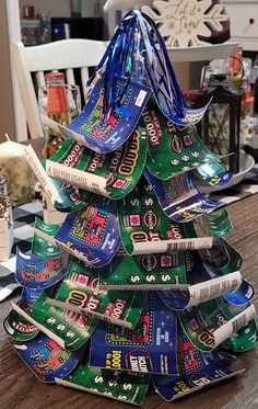 a christmas tree made out of candy bar wrappers on top of a wooden table