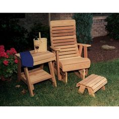 two wooden chairs and a small table in the grass