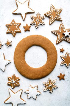 cookies and star shaped biscuits arranged in the shape of a circle on a white surface