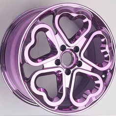 a purple wheel with hearts painted on the front and side, sitting against a white background