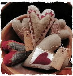 a bowl filled with lots of different types of stuffed animals and tags on the handles