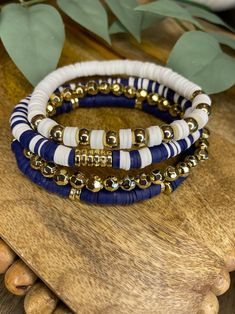 Navy Blue,white, Gold Bracelet Stack - Etsy Cheap Beachy Blue Beaded Bracelets, Cheap Handmade Blue Beaded Bracelets, Navy Clay Bead Bracelet, Navy Beaded Bracelets, Dark Bracelet Ideas, Bead Bracelet Ideas Color Combinations, Clay Bead Bracelet Stack Ideas, Clay Bead Bracelet Ideas Sports, Navy Blue Bracelet