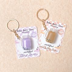 two key chains that are shaped like jars