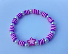 a purple and white bracelet with a pink star on the bead, silver beads and pearls