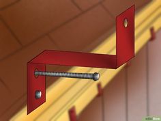 a red shelf with two screws attached to it