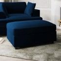 a blue couch and ottoman in a living room