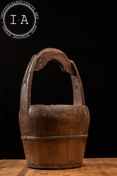 an old wooden basket sitting on top of a table