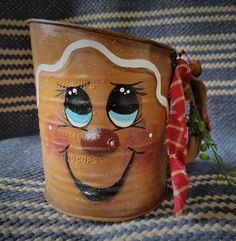 a ceramic mug with a face painted on it