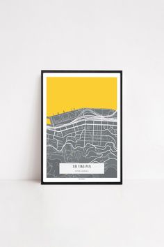 a yellow and grey poster with the words salt lake city on it in front of a white wall