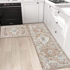 a kitchen with an area rug on the floor next to the stove and dishwasher