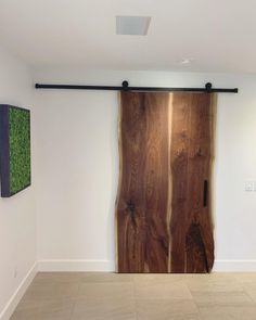 a large wooden door in a white room