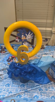 a table topped with a blue and yellow cloth covered tablecloth