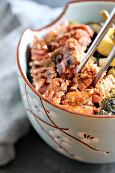 a close up of a bowl of food with broccoli and other foods in it