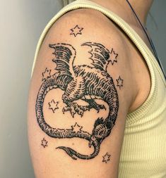 a woman with a dragon tattoo on her arm