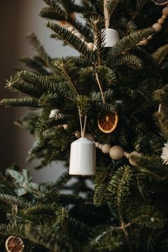 an ornament hanging from the top of a christmas tree