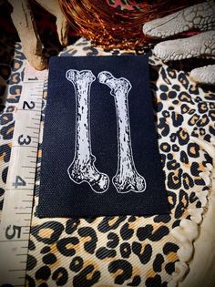 a close up of a piece of cloth with a drawing of two bones on it