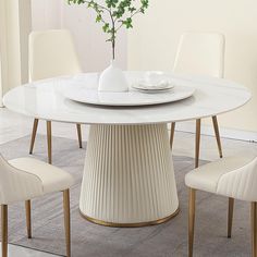 a white table with four chairs around it