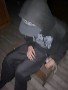 a blurry image of a person sitting on stairs