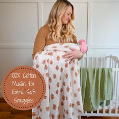 a woman holding a baby wrapped in a blanket with the words 100 % cotton mullin for extra soft snuggles