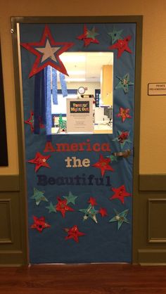 the door to an office decorated with red, white and blue stars that read america the beautiful