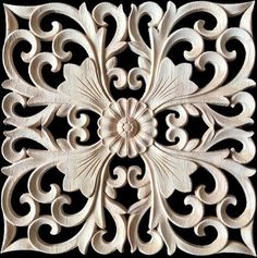 an intricately carved wood panel with swirls and scrolls