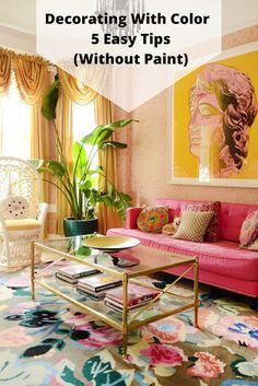 a living room with pink couches and paintings on the wall above them, along with colorful rugs