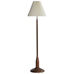 a floor lamp with a white shade on it's base and a wooden pole