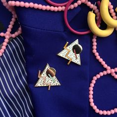 some pink beads and other items on a blue shirt