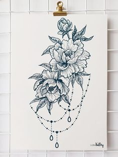 a drawing of flowers on a white paper with blue water drops hanging from the side