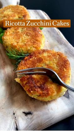 two pieces of food on a plate with a fork in it and the words ricotta zucchini cakes above them