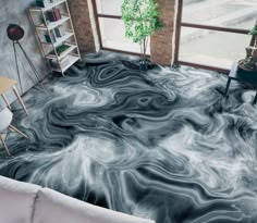 a living room with an artistic floor covering in black and white marbled paint on the floor