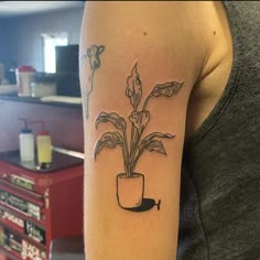 a woman's arm with a potted plant on it