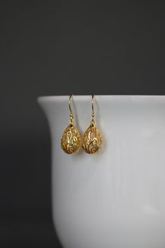 Elegant bright 24k gold vermeil filigree charms dangle from 24k gold vermeil earwires. Choose from 24k gold vermeil balled earwires (as shown and sent with stoppers for the ends of the wires) or plain 24k gold vermeil leverback earwires (these close in the back). Wear these elegant earrings everyday as they complete any outfit. Gold filigree charms: 11x18mm Total length of earrings: 1 1/4" Length is approximate.  All gold is 24k gold vermeil, 24k gold plating over sterling silver. As the owner, Teardrop-shaped Gold Plated Filigree Jewelry, Gold Plated Filigree Teardrop Jewelry, Elegant Gold Teardrop Pendant Earrings, Gold Teardrop Pendant Jewelry With Matching Earrings, Delicate Gold Hypoallergenic Earrings, Delicate Hypoallergenic Gold Earrings, Gold Teardrop Pierced Earrings, Gold Teardrop Earrings With Pearl Drop For Formal Occasions, Formal Gold Teardrop Earrings With Pearl Drop