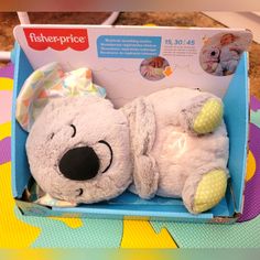 a white stuffed animal in a blue box