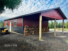 a tractor is parked in front of a building with wood stacked on the outside and inside