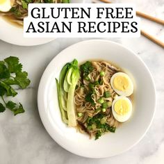 two plates filled with noodles and topped with hard boiled eggs, as well as garnishes