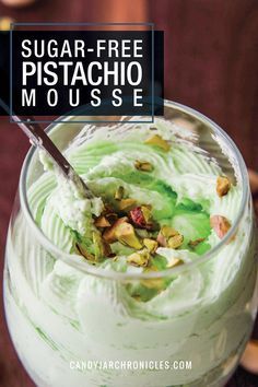 a close up of a dessert in a glass on a table with text overlay that reads sugar - free pistachio mousse