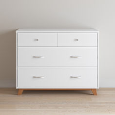 a white dresser sitting on top of a hard wood floor