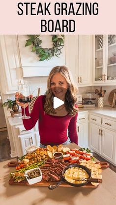 a woman standing in front of a table full of food and wine with the words how to make a steak grazing board