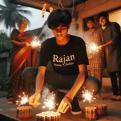 a group of people holding sparklers in their hands and sitting on the ground next to them