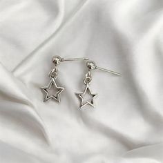 Enhance your look with these dainty star earrings, beautifully handcrafted in sterling silver. Featuring a delicate star design, these earrings bring a touch of celestial elegance to any outfit. Perfect for sensitive ears, they offer both comfort and a timeless charm. ● 4mm 925 sterling silver stud post  ● about 1.5cm alloy shooting star charm  💎Sterling Silver: Provides durability and a sleek, polished finish. 💎Handmade Craftsmanship: Each pair is meticulously crafted for unique quality. 💎Da Silver Earrings Dangle Stars, Silver Star Dangle Earrings, Sterling Silver Celestial Drop Earrings, Celestial Sterling Silver Drop Earrings, Silver Star Gothic Earrings, Moon Earring, Celestial Earrings, Basic Jewelry, Minimalist Gifts