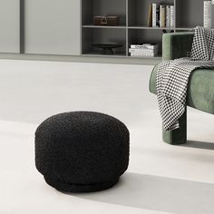 a chair and ottoman in a room with bookshelves