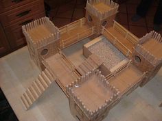 a wooden model of a castle made out of wood planks and plywood boards