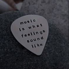 a guitar pick that says music is what feelings sound like