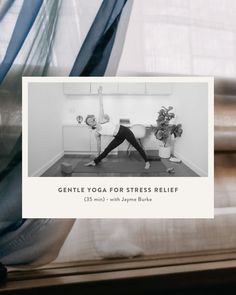 a woman doing yoga in front of a window